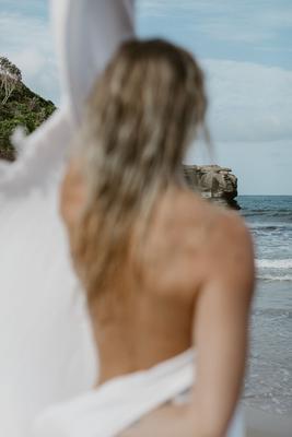 Bare back over the shoulder against the sea