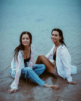 Friends seated in the shallows, coastal lifestyle