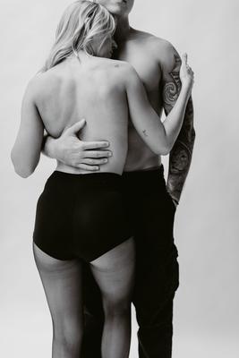 Held from behind, black and white couples boudoir