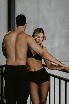 Couples boudoir Newcastle, embrace at the balcony rail