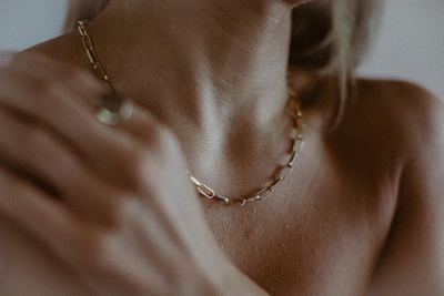 Gold chain at the collarbone, editorial detail by a photographer in Newcastle